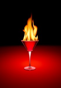 Image of flaming red liquid in a cocktail glass